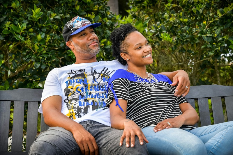 Photo of smiling couple relaxing on a bench